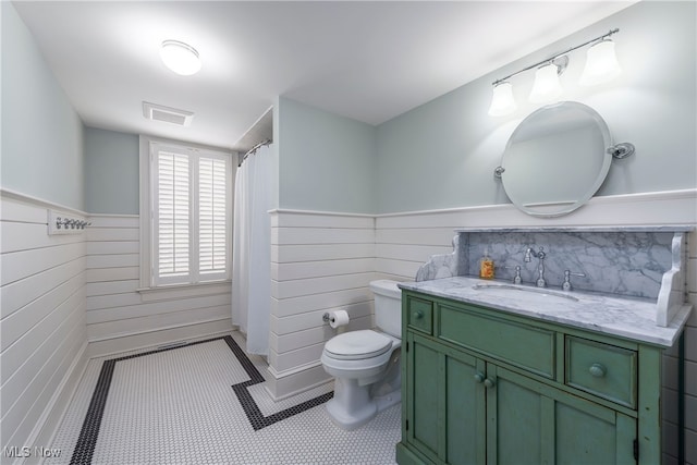 bathroom featuring vanity, toilet, and tile patterned flooring