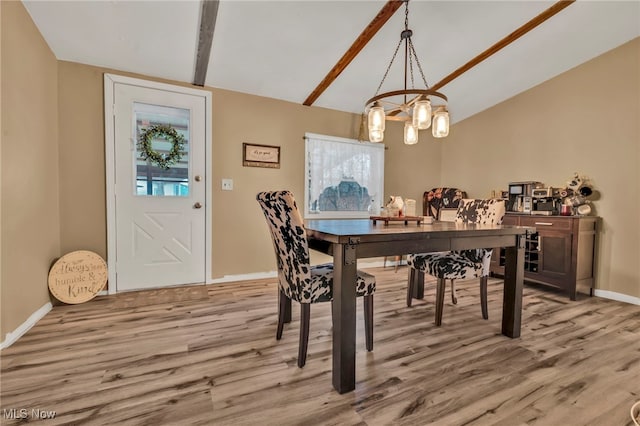 dining space featuring lofted ceiling with beams and light hardwood / wood-style floors