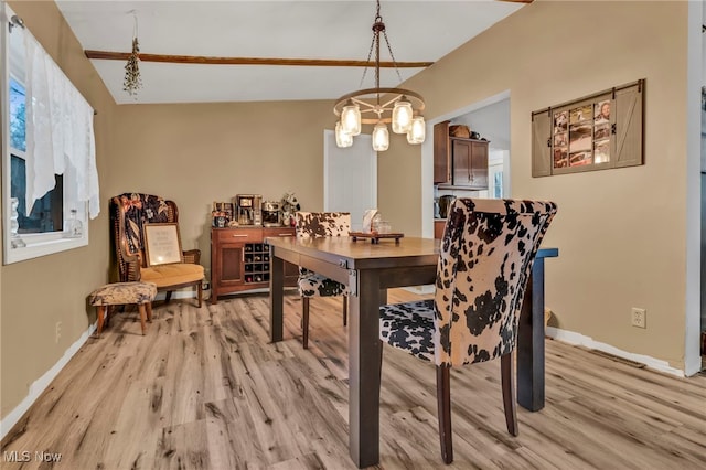 dining room with a notable chandelier and light hardwood / wood-style floors