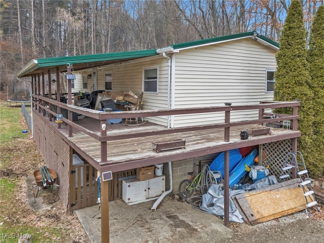 back of property with a wooden deck