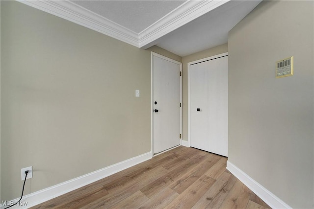 interior space with crown molding and light wood-type flooring