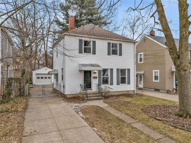 view of front of property with a garage and an outdoor structure