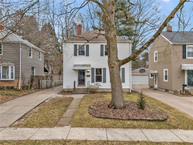 view of front of property featuring a garage and an outdoor structure