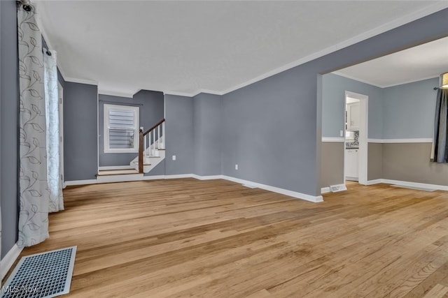 unfurnished living room featuring crown molding and light hardwood / wood-style floors