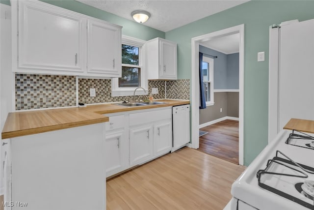 kitchen featuring white cabinetry, white appliances, sink, and tasteful backsplash