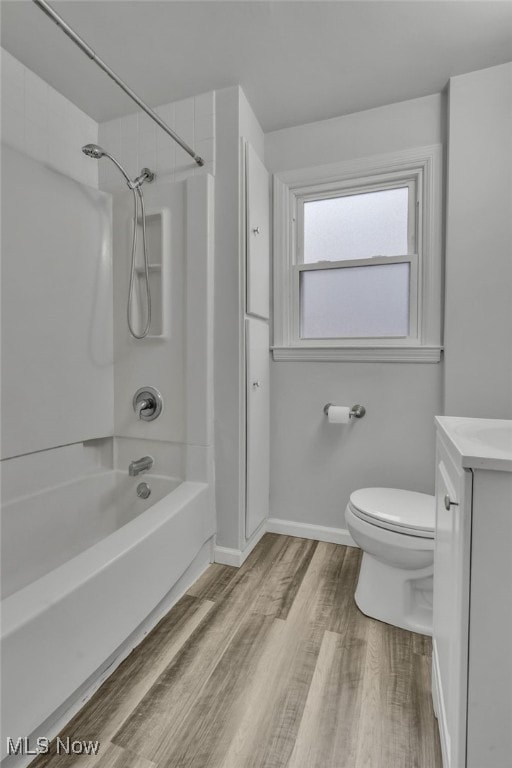 full bathroom featuring vanity, wood-type flooring,  shower combination, and toilet