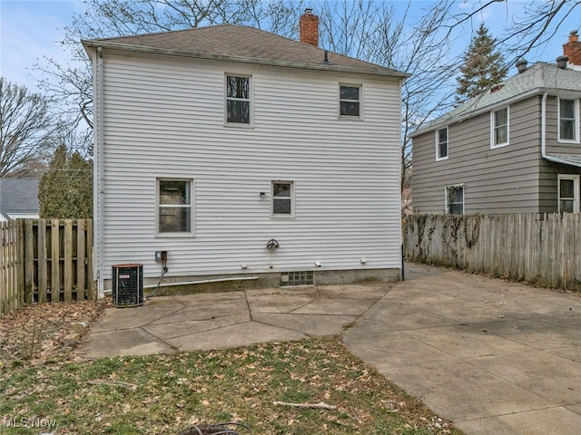 rear view of house featuring central AC and a patio area