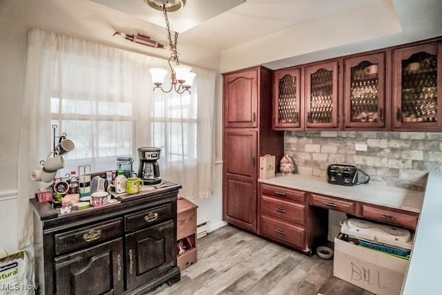 bar with an inviting chandelier, tasteful backsplash, light hardwood / wood-style flooring, pendant lighting, and a baseboard heating unit