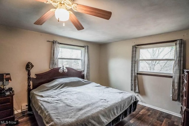 bedroom with ceiling fan and dark hardwood / wood-style flooring