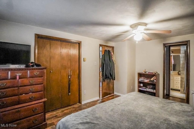 bedroom with ceiling fan, dark hardwood / wood-style floors, and ensuite bath