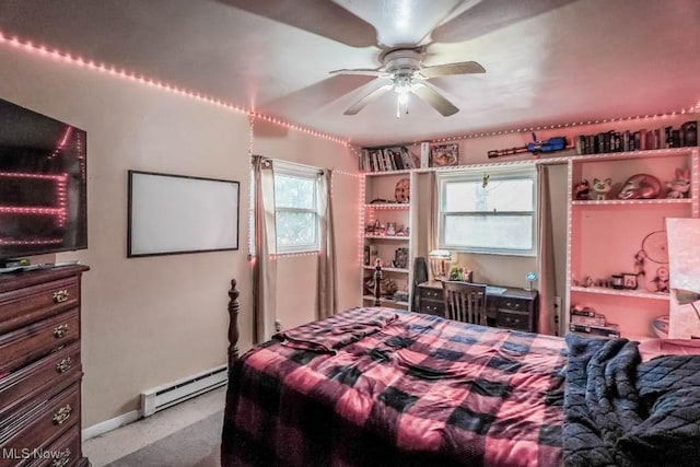 bedroom with a baseboard heating unit and ceiling fan