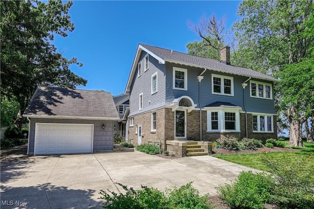 17728 Windward Rd, Cleveland, OH 44119 - view of front of home featuring a chimney, a garage, and an outdoor structure