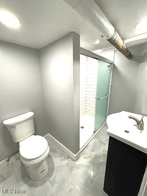 bathroom featuring walk in shower, vanity, and toilet