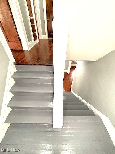 stairway featuring wood-type flooring