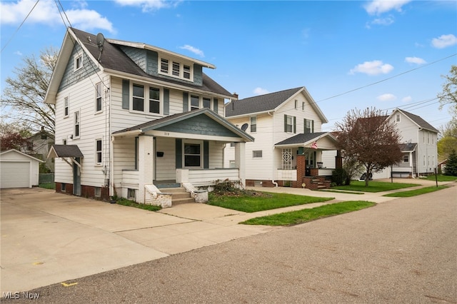 view of front of house featuring an outbuilding, a garage, and a porch