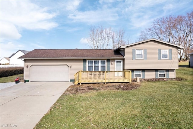 split level home featuring a wooden deck, a garage, and a front lawn