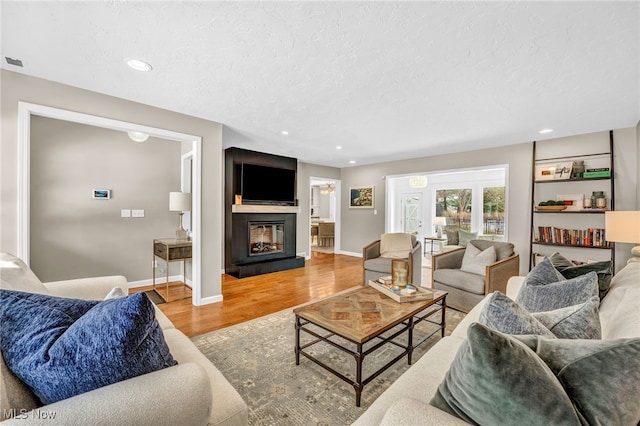 living room with hardwood / wood-style flooring and a textured ceiling