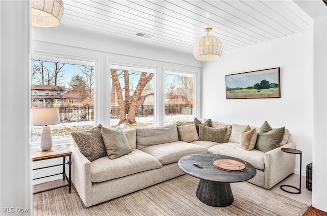 living room featuring wood-type flooring and wooden ceiling