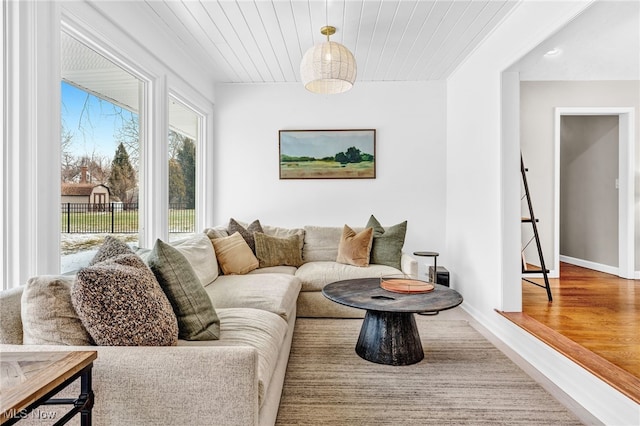 living room featuring wood ceiling and hardwood / wood-style flooring