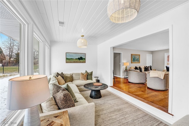 living room featuring hardwood / wood-style flooring and wood ceiling