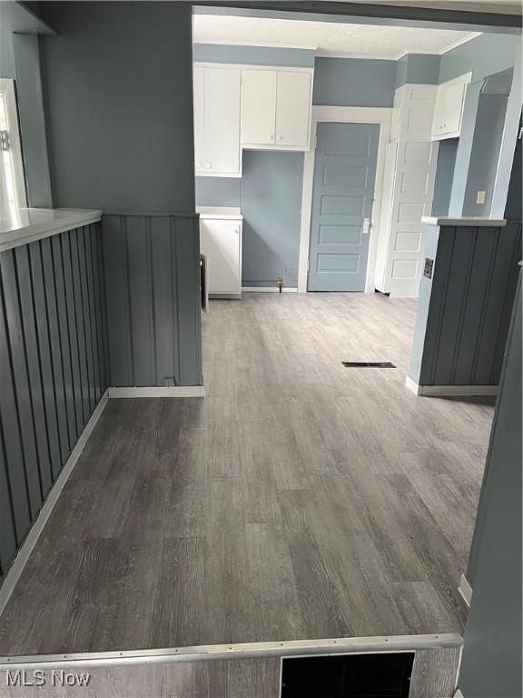 kitchen featuring dark wood-type flooring and white cabinets