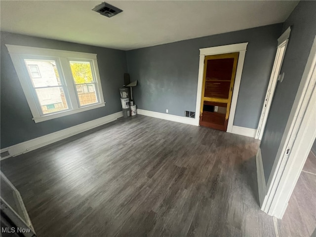 unfurnished living room featuring dark hardwood / wood-style floors