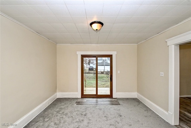 doorway with crown molding and carpet flooring