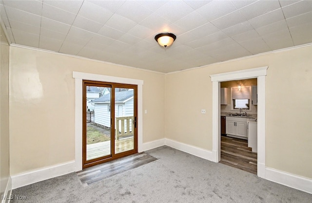 carpeted spare room featuring ornamental molding