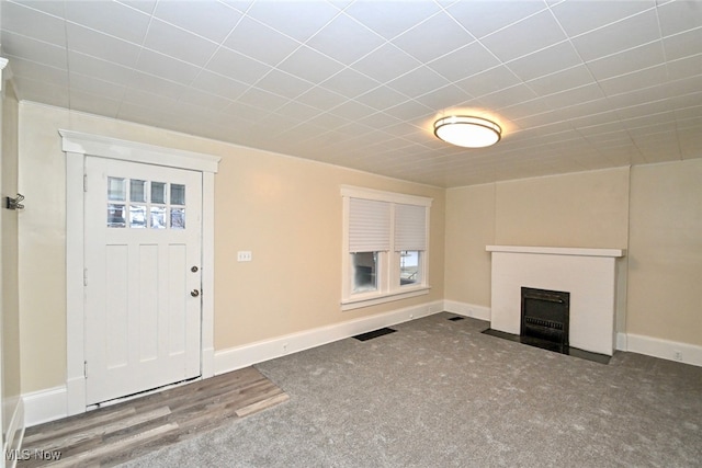 unfurnished living room featuring carpet