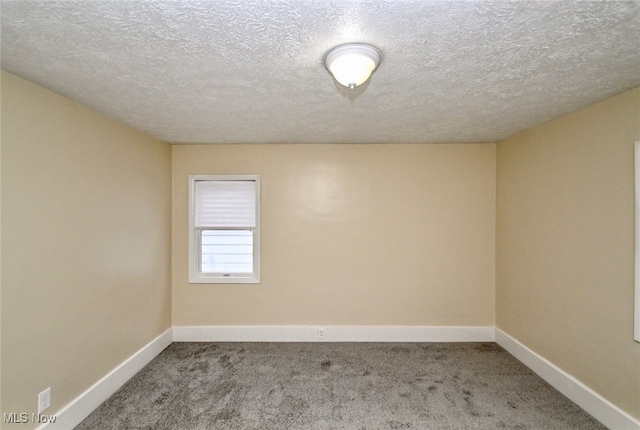 spare room with carpet floors and a textured ceiling