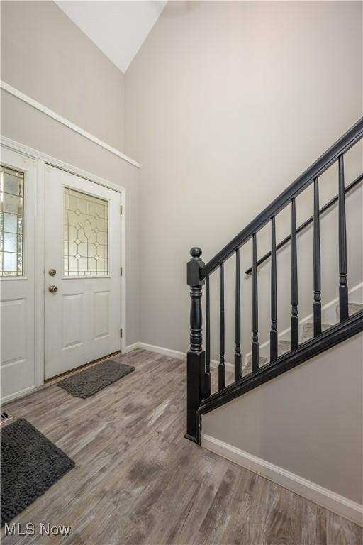 1145 Cookhill Cir, Akron, OH 44312 - foyer featuring stairs, wood finished floors, baseboards, and high vaulted ceiling
