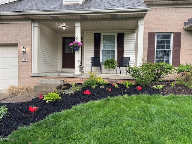 1145 Cookhill Cir, Akron, OH 44312 - property entrance with covered porch, a shingled roof, and brick siding