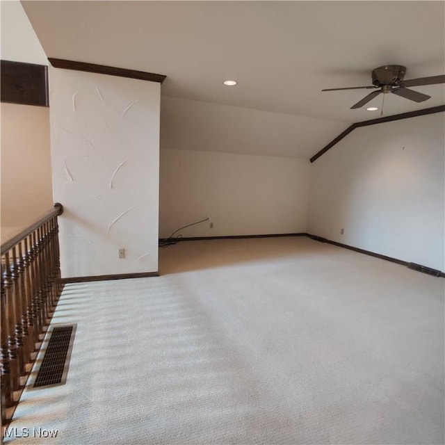 bonus room featuring vaulted ceiling, light colored carpet, and ceiling fan