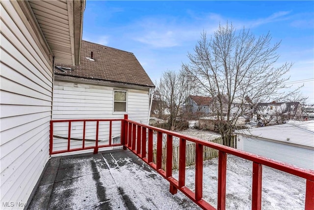 snow covered deck featuring a garage