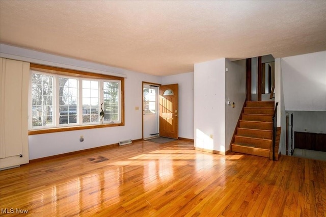 interior space featuring light hardwood / wood-style flooring and a textured ceiling