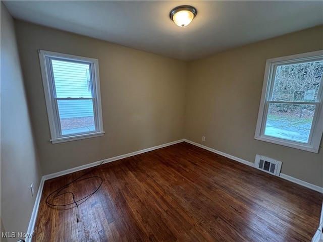 spare room featuring dark wood-type flooring