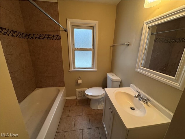 full bathroom with tile patterned floors, vanity, toilet, and tiled shower / bath combo