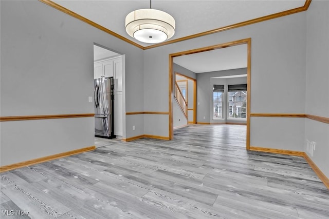 interior space with ornamental molding and light hardwood / wood-style floors