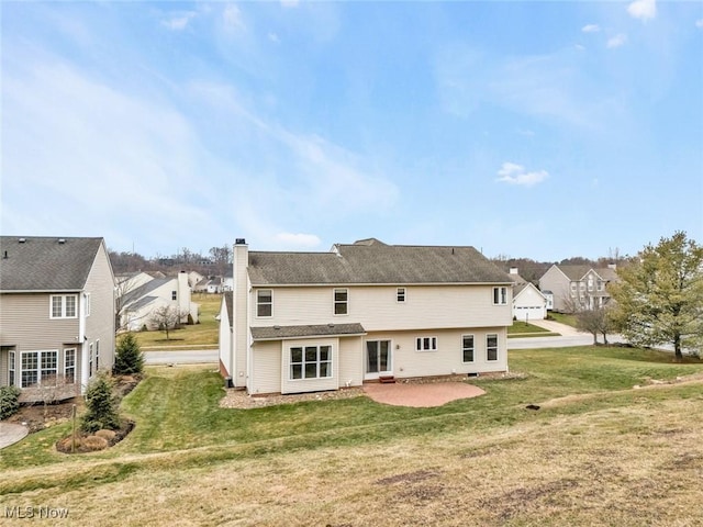 back of property featuring a yard and a patio area