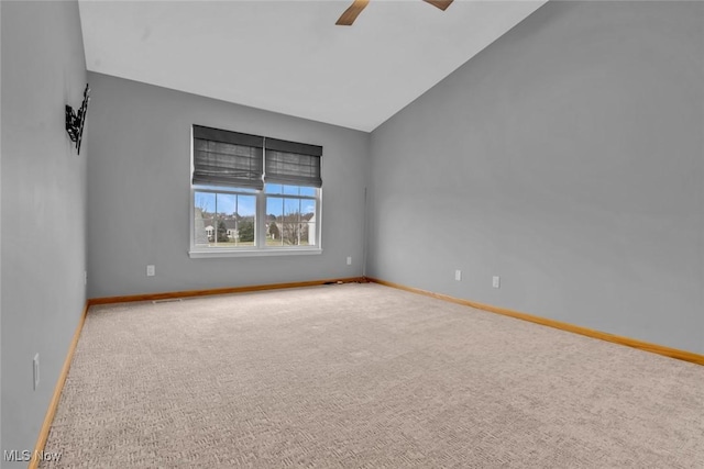 carpeted empty room with vaulted ceiling and ceiling fan