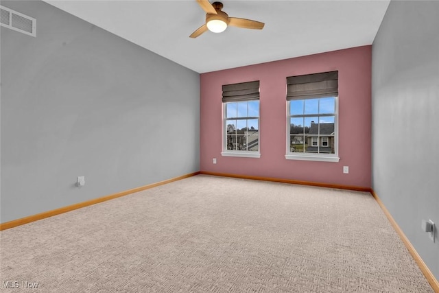 empty room with ceiling fan and carpet