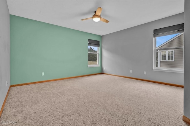 unfurnished room with ceiling fan and carpet flooring