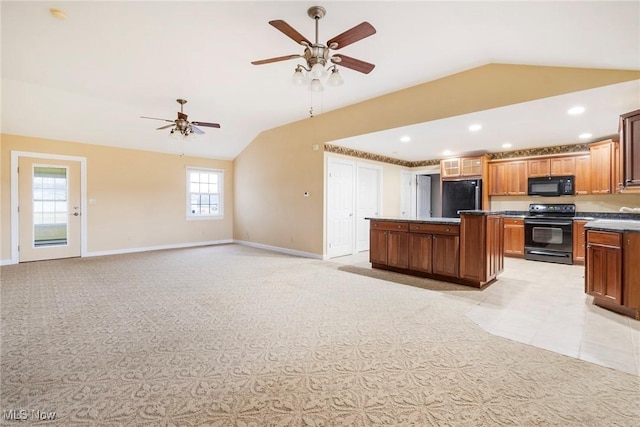 kitchen with light carpet, vaulted ceiling, black appliances, and a kitchen island