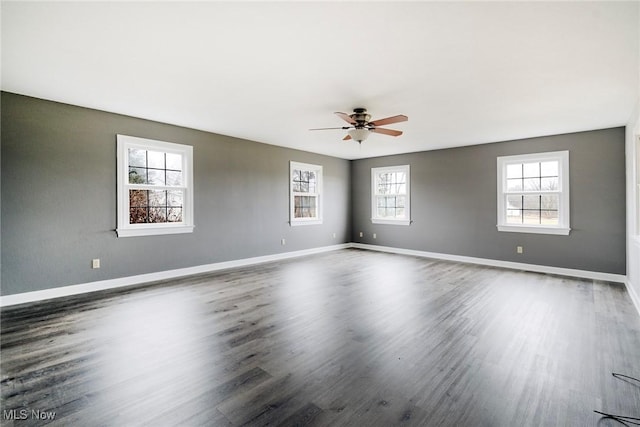 empty room featuring dark wood-type flooring and ceiling fan