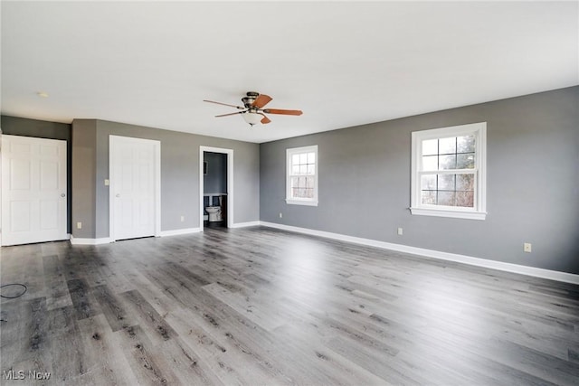 empty room with hardwood / wood-style floors and ceiling fan