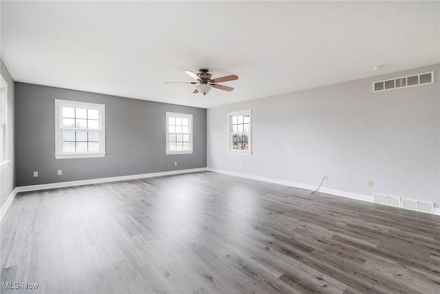 spare room featuring ceiling fan and dark hardwood / wood-style floors