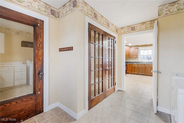 corridor featuring light tile patterned floors and french doors