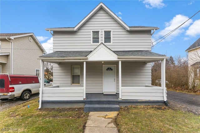 bungalow-style house with a porch and a front yard