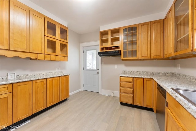 kitchen featuring light stone countertops, sink, stainless steel dishwasher, and light wood-type flooring