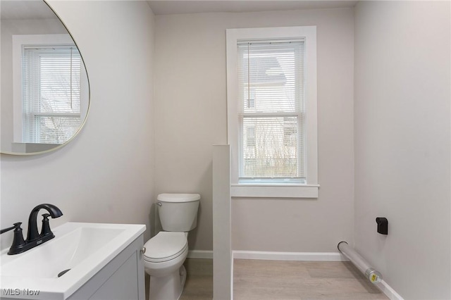 bathroom featuring vanity, toilet, and hardwood / wood-style floors